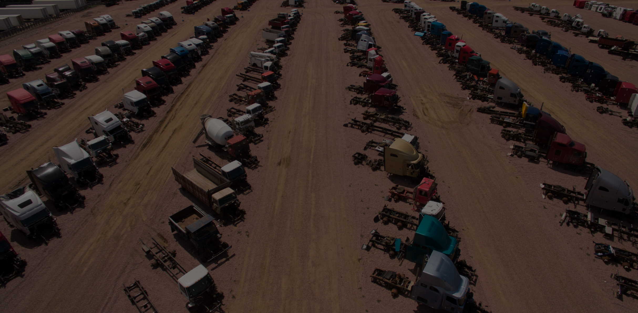 Aerial view of a salvage yard filled with truck units