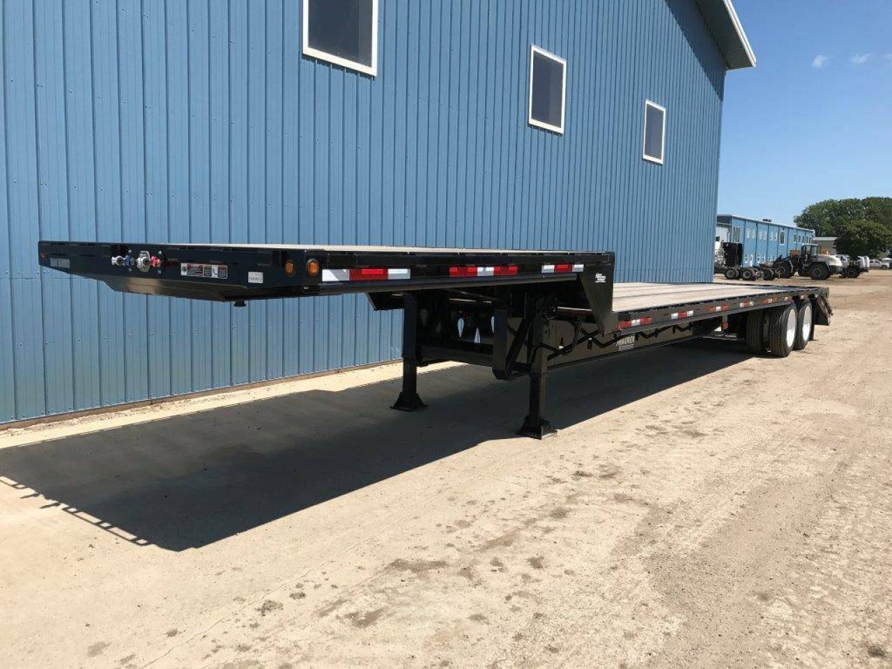 Step deck trailer parked in the yard